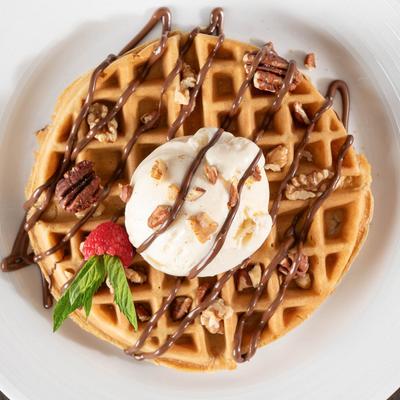 Nutella Waffle topped with a scoop of vanilla ice cream.
