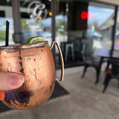 A hand holding a cocktail.