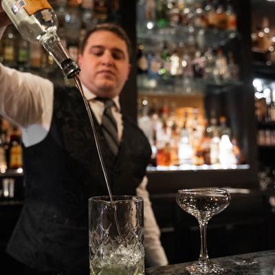bartender pouring a drink.