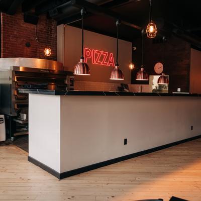 Pizza kitchen with a counter.