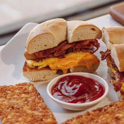 Bacon, eggs, and cheese sandwich with ketchup dip.