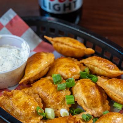Buffalo chicken ravioli, fried and served with a dipping sauce.