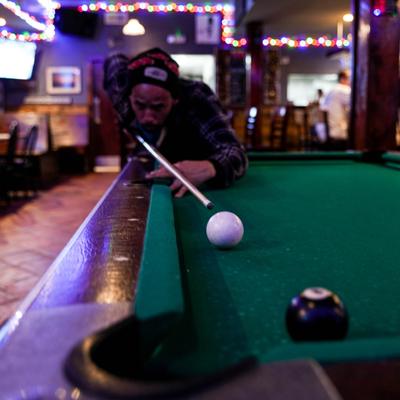 Customer playing billiard