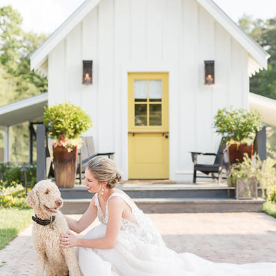 Girl in the weeding dress with a dog