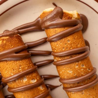 Crepes drizzled with chocolate, close up.