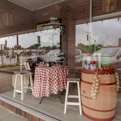 Restaurant's front window with seats and decorations.