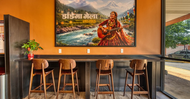 Interior, high seating area, large format Nepalese folk inspired painting, shop window