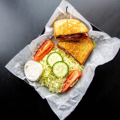 A served sandwich with a salad on the side.