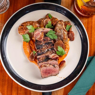 New York strip steak with smoked tomato chimichurri, and Spanish fried potatoes.