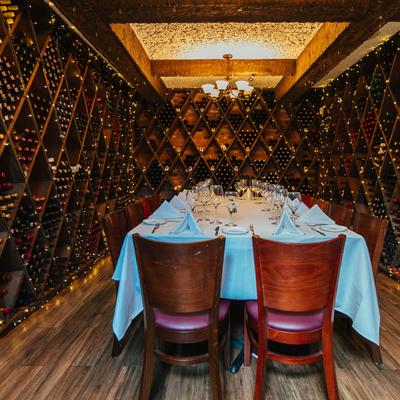 Wine cellar, fully set dining table.