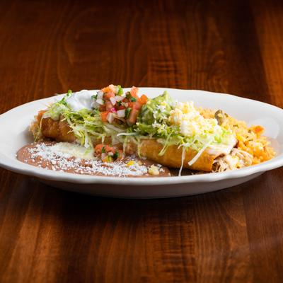 Flautas with lettuce, pico de gallo, guacamole, refried beans, and seasoned rice.