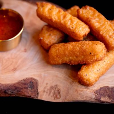 Mozzarella sticks served with marinara sauce.