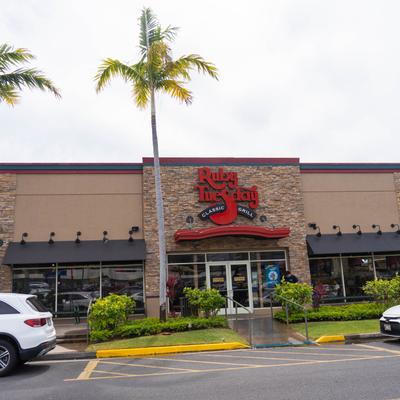 Exterior, front view of the  entrance, part of a parking lot.