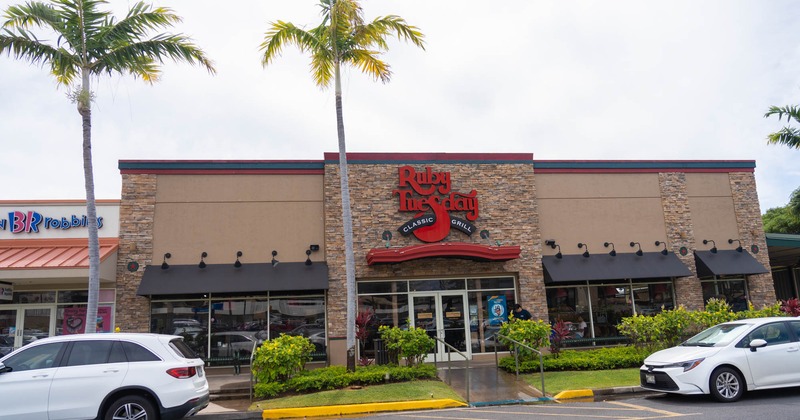 Exterior, front view to entrance, part of a parking lot