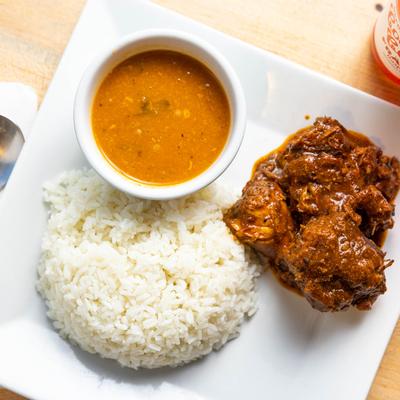 Chicken stew served with white rice and dressing, top view