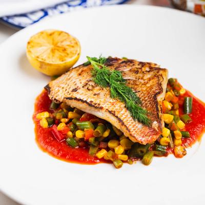 Fresh tuna served over mixed vegetables and puttanesca sauce.