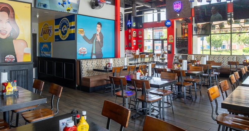Interior, dining area, thick wooden top tables with chairs, entrance, large shop window