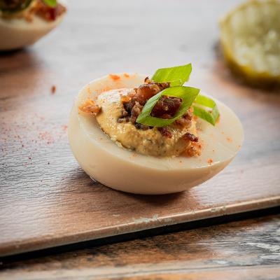 Deviled eggs topped with bacon and scallions.