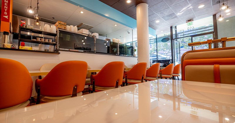 Interior, tables and chairs near bar