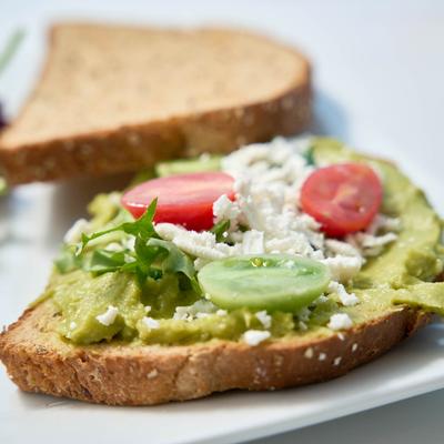 Avocado, feta, arugula, and grape tomato sandwich.