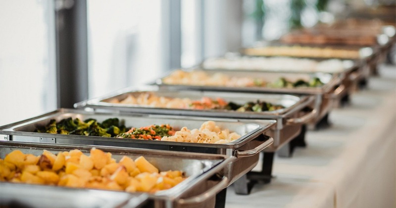 Close up of a row of catering food trays on a table