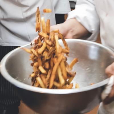 Kitchen action shots, fries preparation.