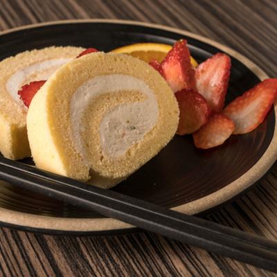 Japanese Swiss roll cake garnished with strawberries.