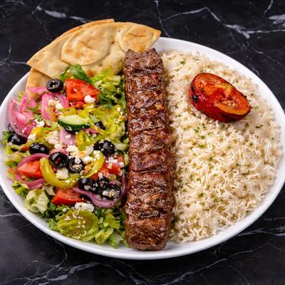 Ground Beef Kabob plate served with rice, Greek pita bread, roasted tomato, and side salad.