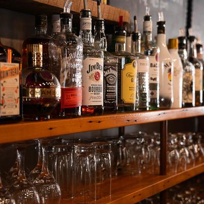 Bar shelves, bottles of liquor and glasses.