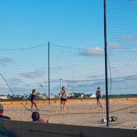 People playing beach volleyball.