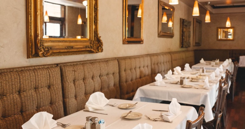 Interior, banquette dining area, tables and chairs ready for guests