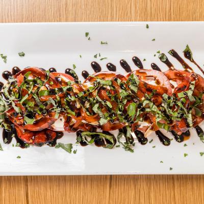 Caprese salad drizzled with balsamic.