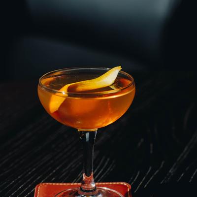 Cocktail with a lemon peel.