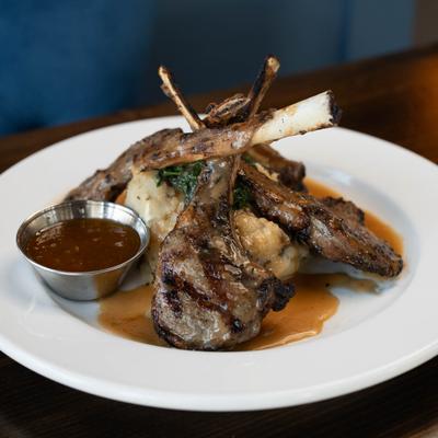 Lamb Lollipops served with meat dressing and pureed garlic mashed potatoes.
