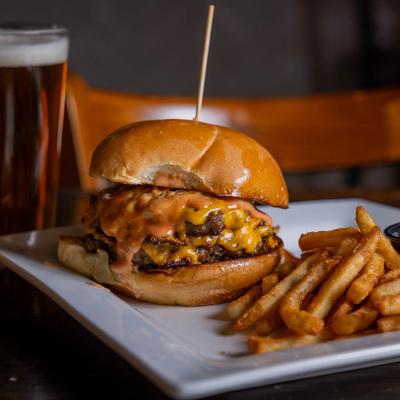 Double cheeseburger with fries and a beer.