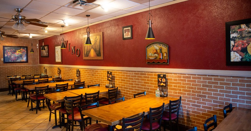 Interior, lined up dining tables and chairs by a wall side, wall artwork