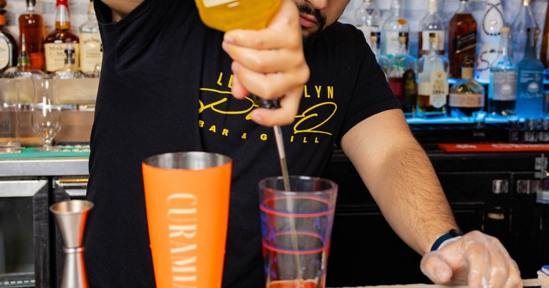 Bartender pouring a cocktail