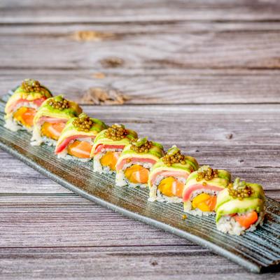 Salmo sushi rolls, topped with tuna, avocado, and roe.