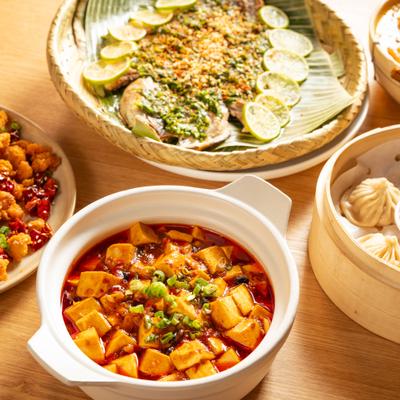 Assorted food dishes including Mapo Tofu and Yunnan-Style Grilled Whole Branzino.