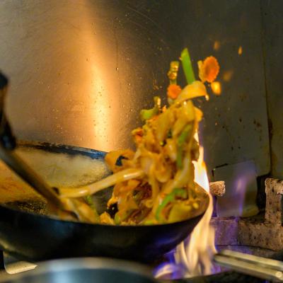 Cooking food in a wok, close up.