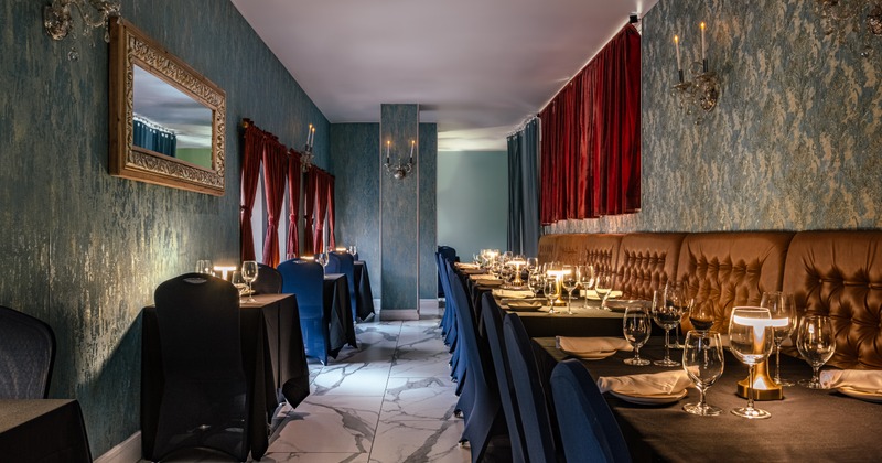 Interior with set tables, chairs, red and blue curtains and marble flooring
