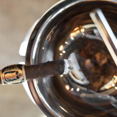 Lit cigar in an ashtray
