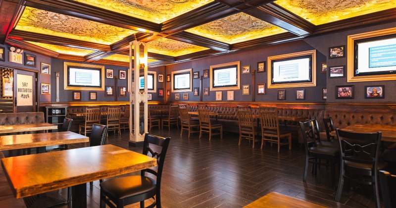 Interior with tables, chairs, and an ornate ceiling
