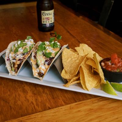 Barbacoa tacos with salsa and chips.