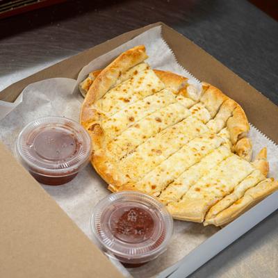 Cheese breadsticks with marinara sauce on the side.
