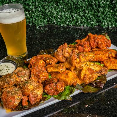 Buffalo wings with a glass of beer.