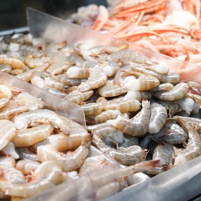 A retail seafood counter featuring various fresh crustaceans.
