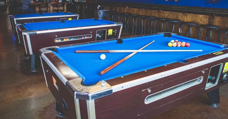 Cues and balls on pool table