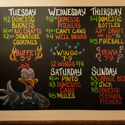Chalkboard menu with weekly drink specials.