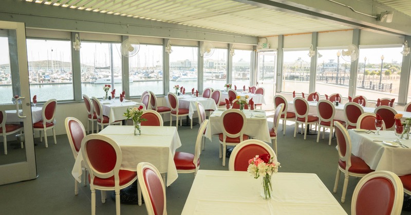 Interior, dining area, entrance, large window area, tables for four and ten, fans